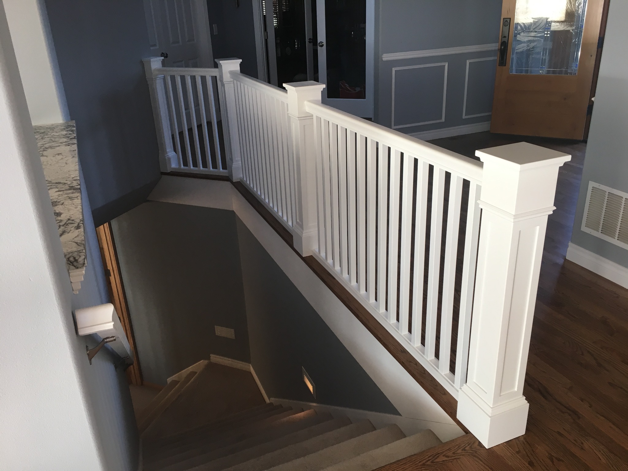 Completed staircase with handmade white railing posts and balusters