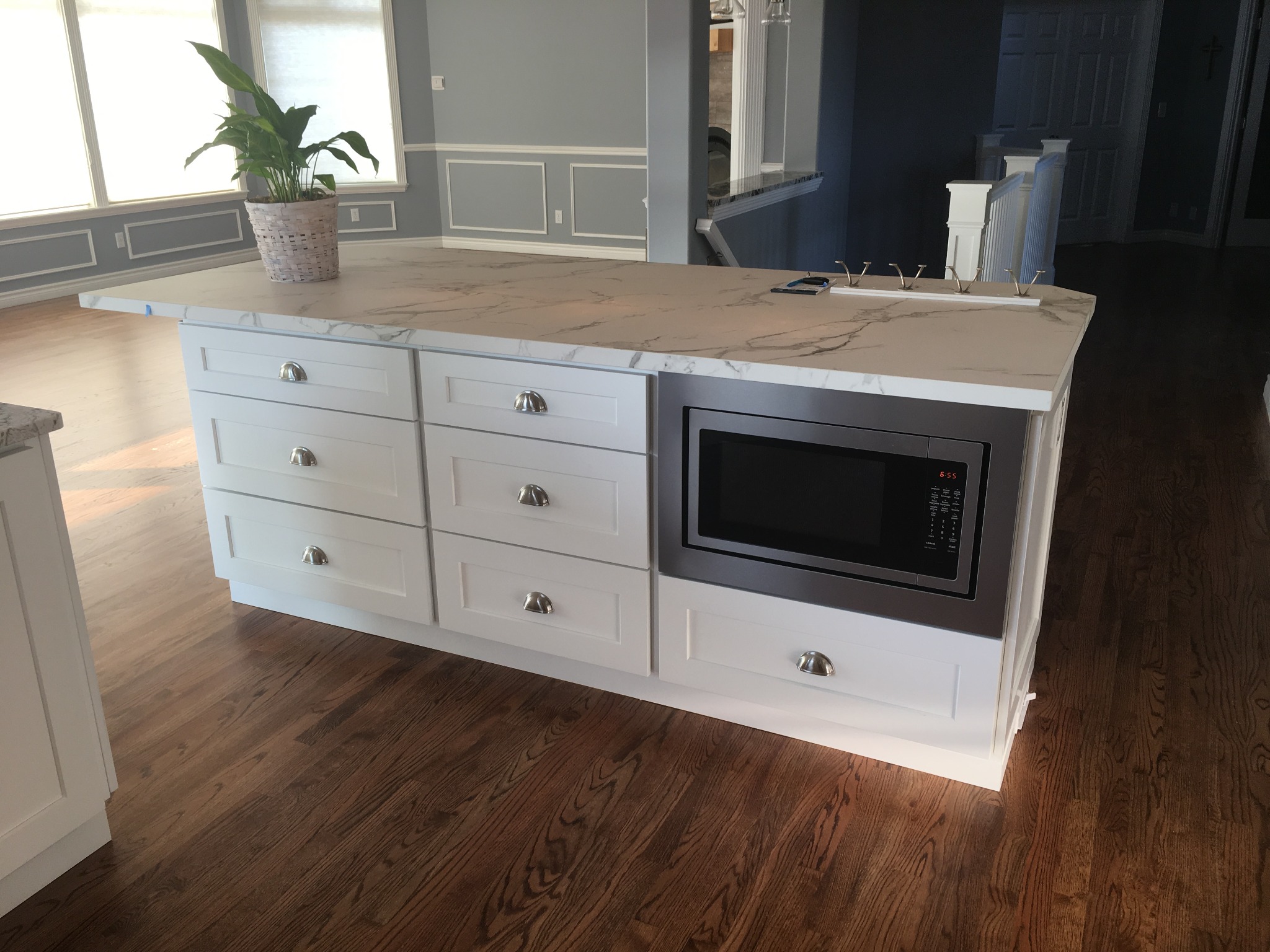 Custom kitchen island with drawers and built-in microwave
