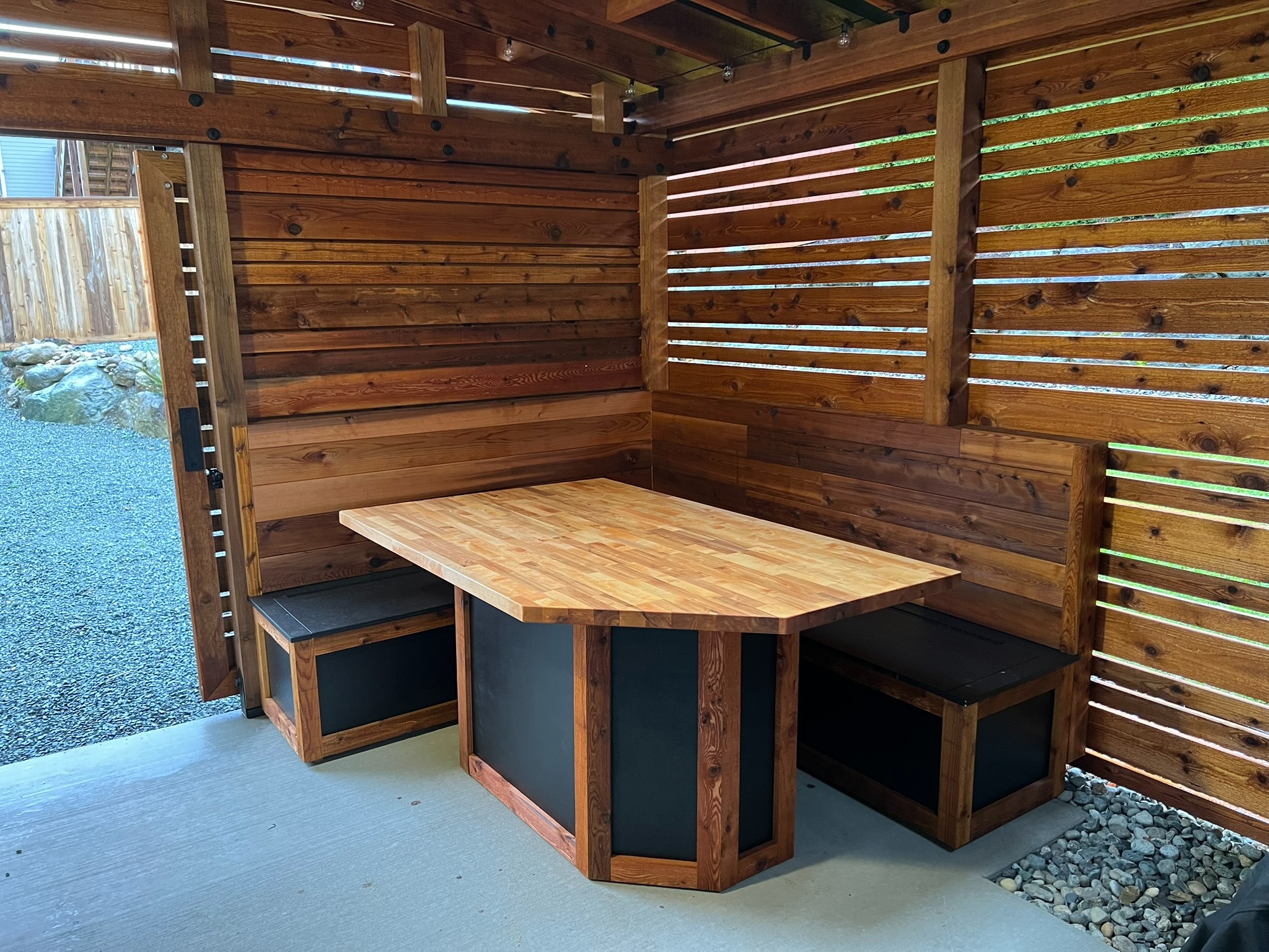 Custom wood table and built-in bench seating inside the garden room
